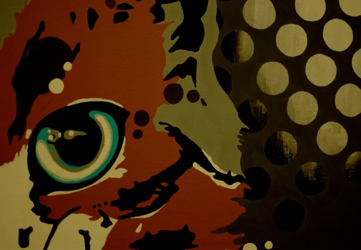 Close-up of the green cat eye among halftone dots