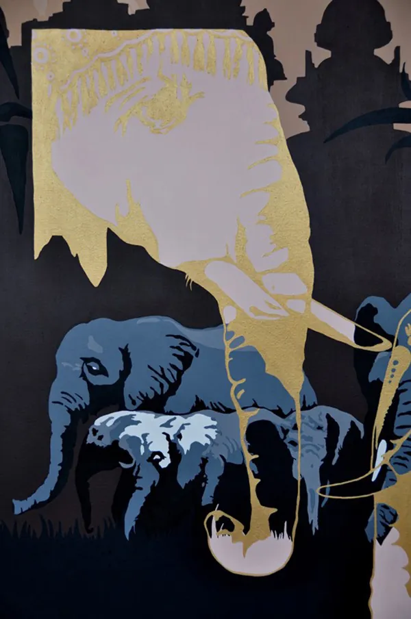 Detail of a herd of elephants with a golden elephant outline