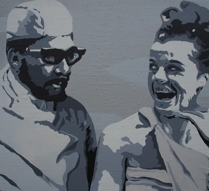 Detail of a man in a surgical cap and glasses beside a laughing woman