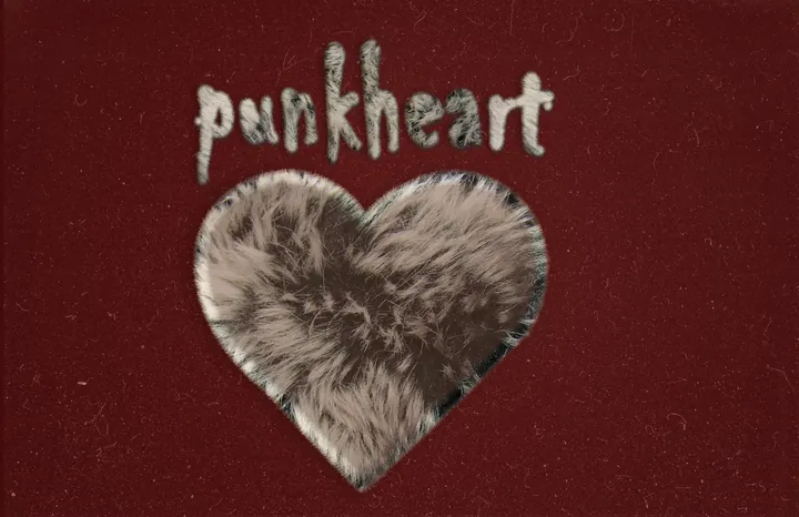 Brown fur heart with handwritten punkheart lettering on dark red