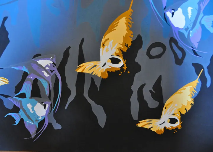 Detail of golden and violet angelfish over dark seaweed