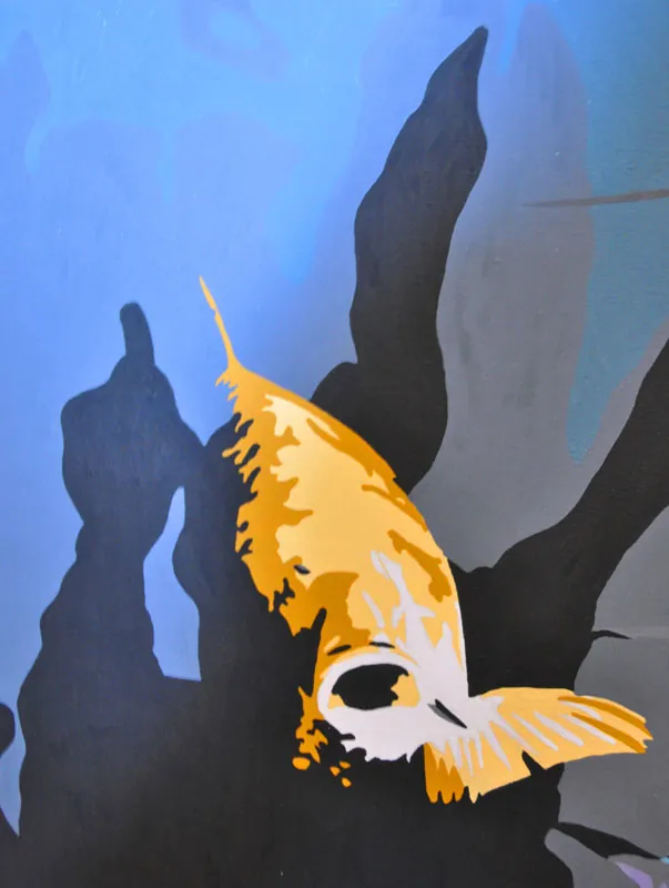 Detail of a golden angelfish against blue water